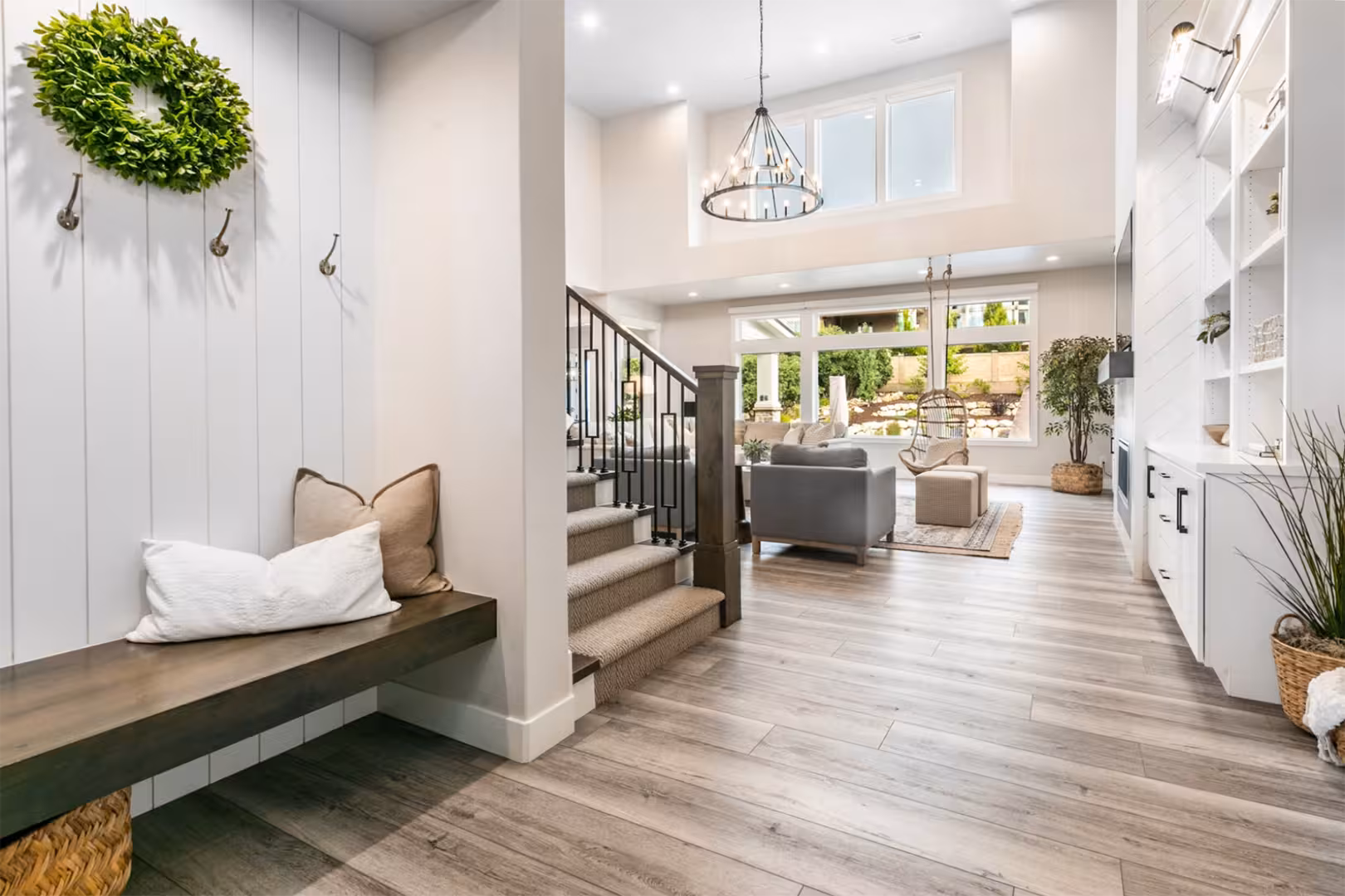 Entry bench and shiplap wall looking into the open living room of the Alpine home