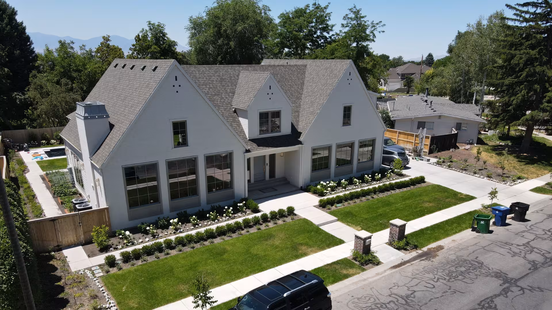 Angled aerial view of the Haven home showing its chimney, side yard and front lawn