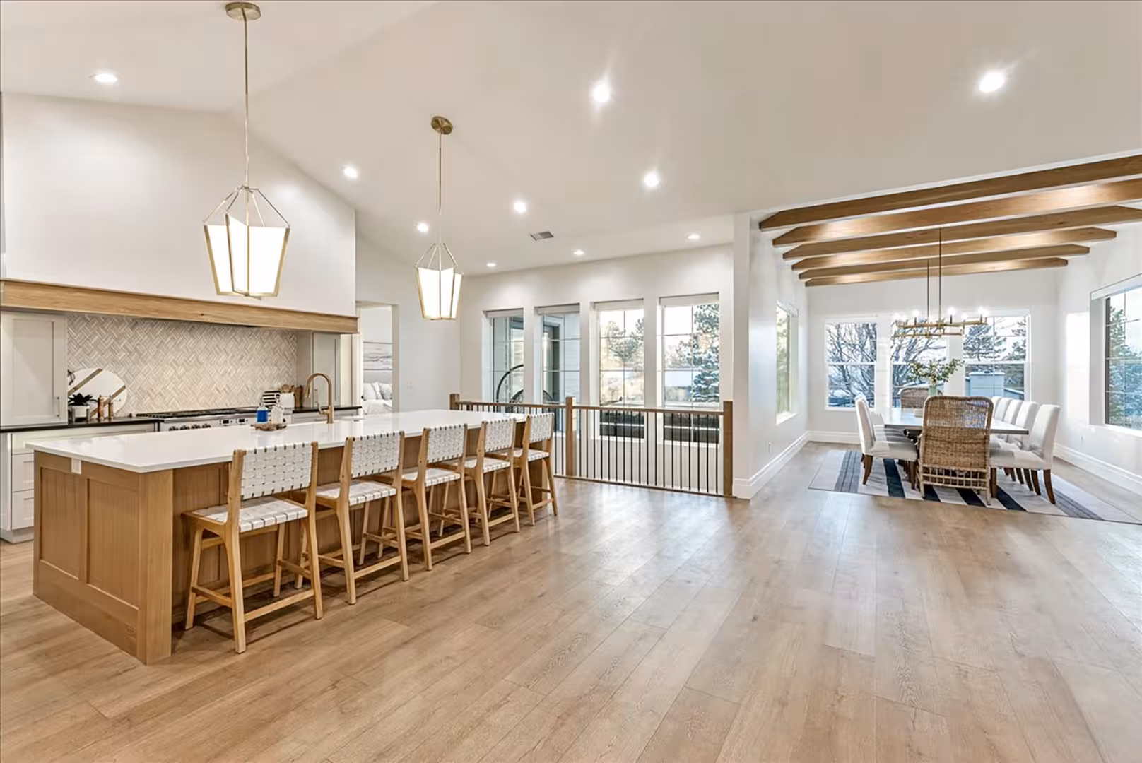 Open kitchen and dining area in the Bountiful home with vaulted ceilings and wood beams