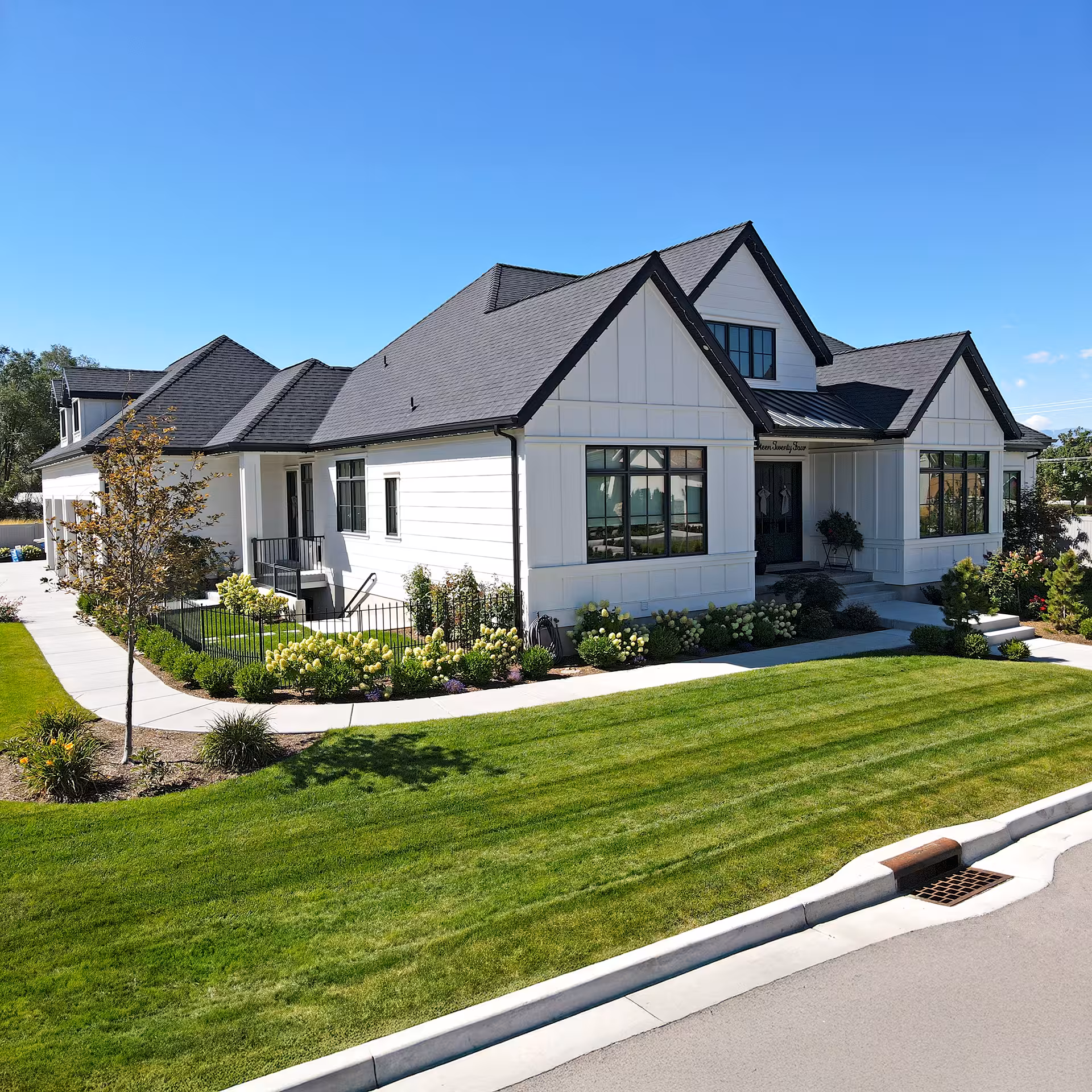 Corner view of the Brighton home with white board and batten siding and black trim
