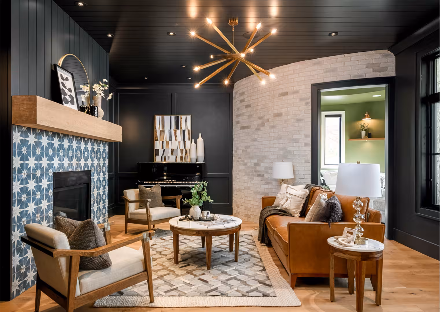 Draper home sitting room with a black ceiling, blue patterned tile fireplace and a leather sofa