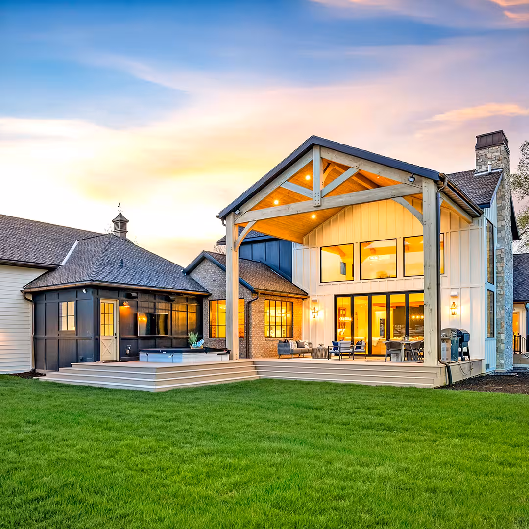 Draper home backyard at sunset with a covered timber patio and a long lawn