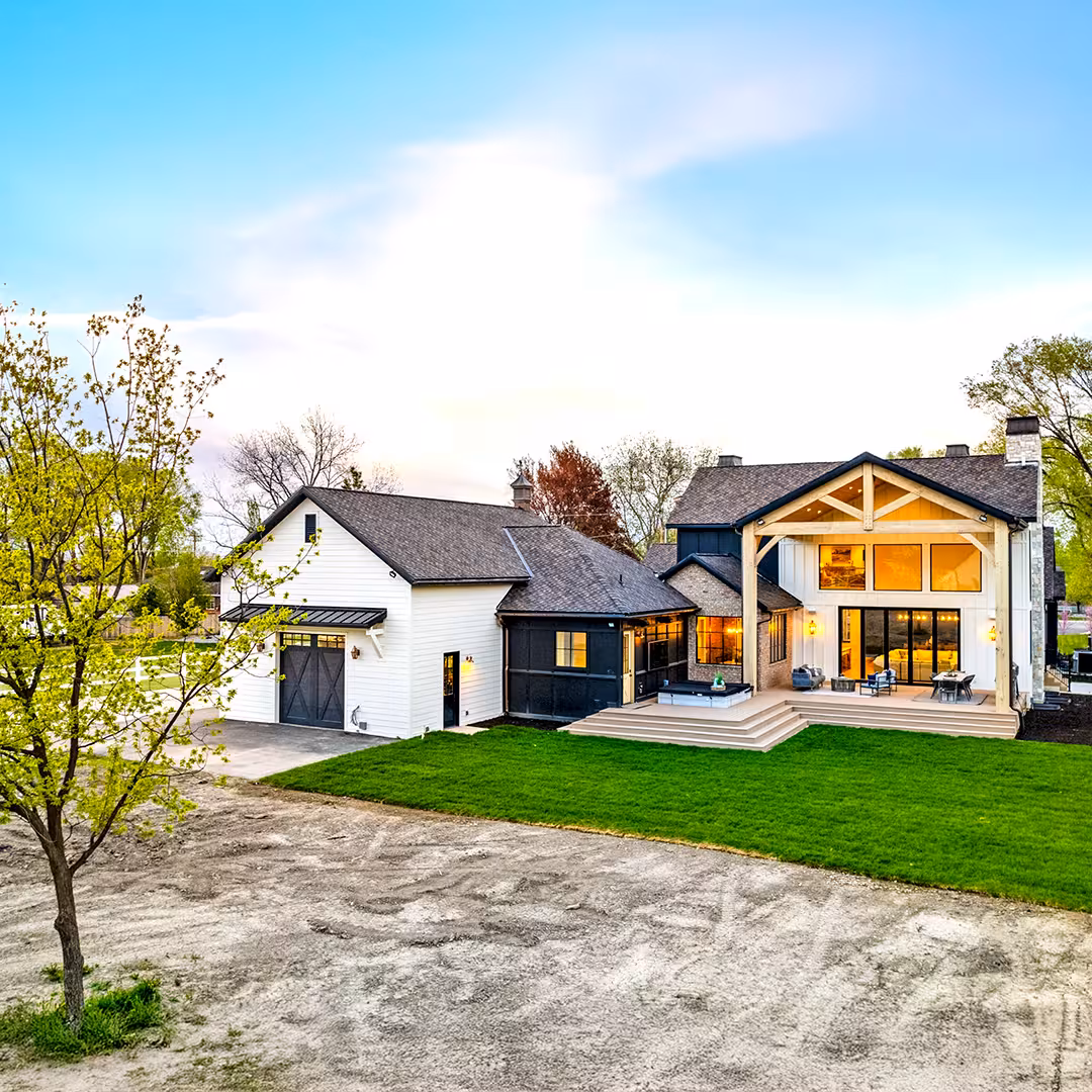 Wide view of the Draper home's rear exterior, detached garage and backyard deck