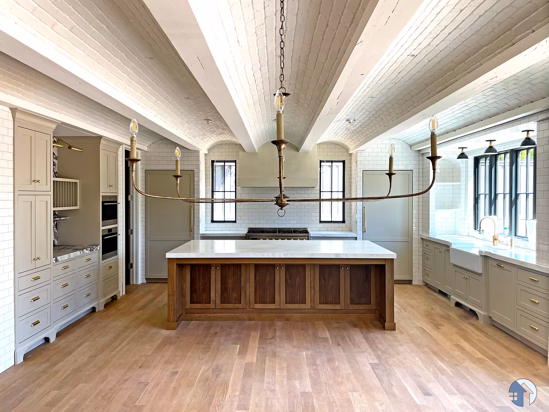 Holladay home kitchen with a walnut island, white tile walls and a wood beam ceiling