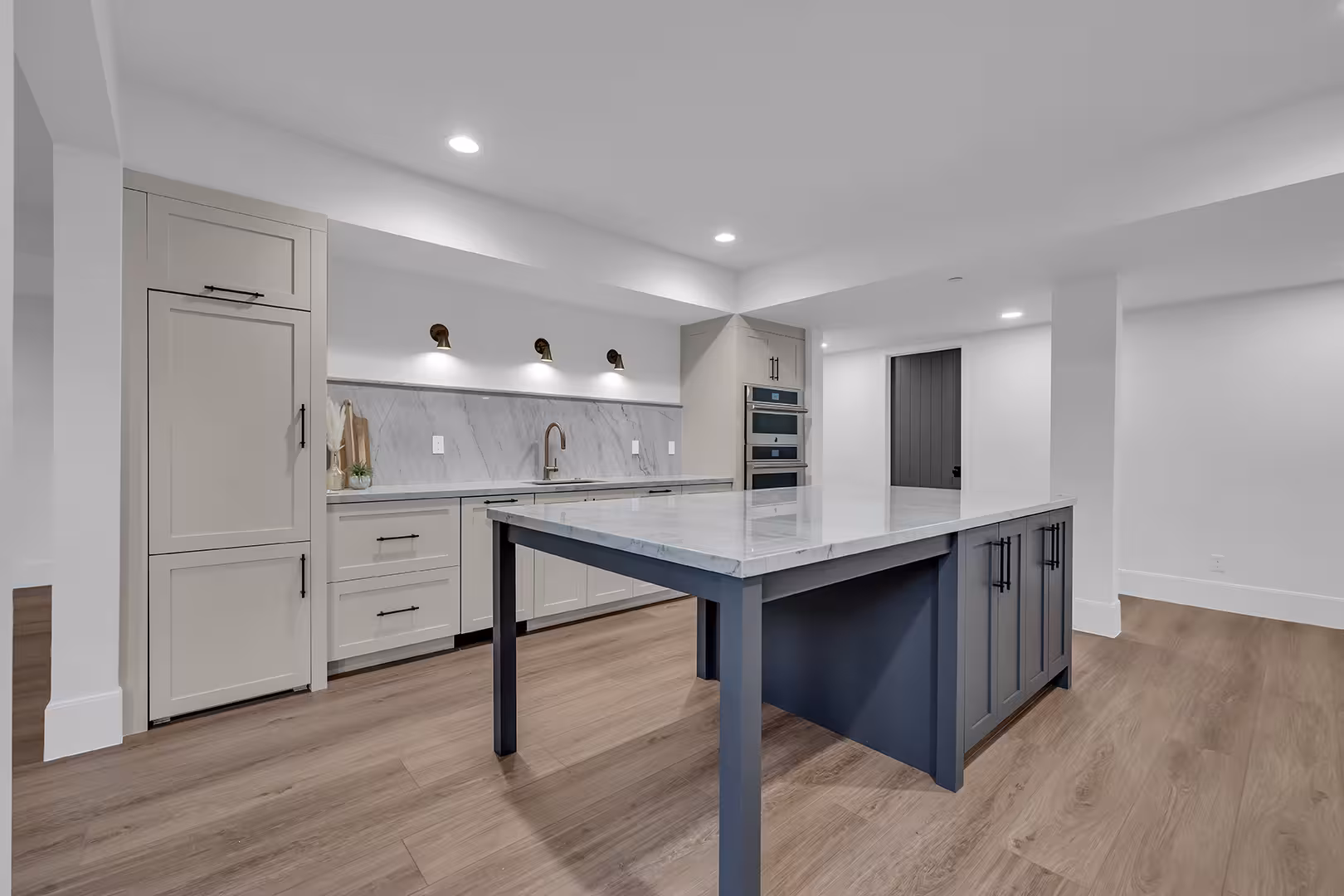 Basement kitchenette in the Elk Ridge home with a navy island and light gray cabinets