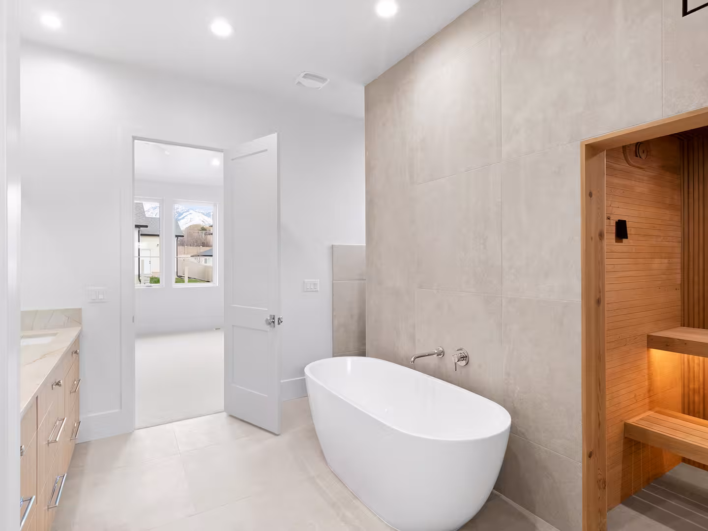 Jordan primary bathroom with a soaking tub and a wood-lined sauna