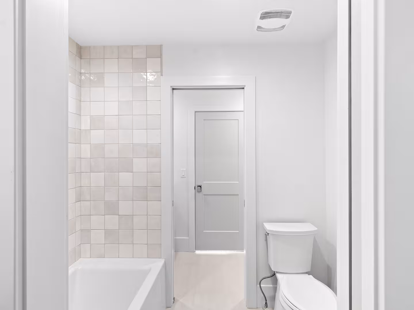 Jordan home bathroom with square cream tile around the tub