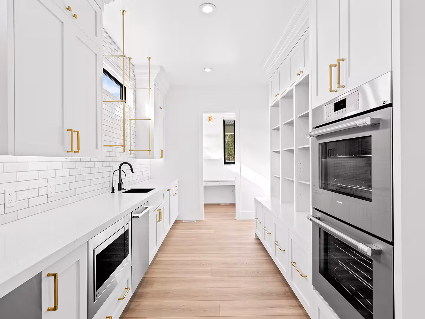 Lehi butler's pantry with double wall ovens, open shelves and white cabinets