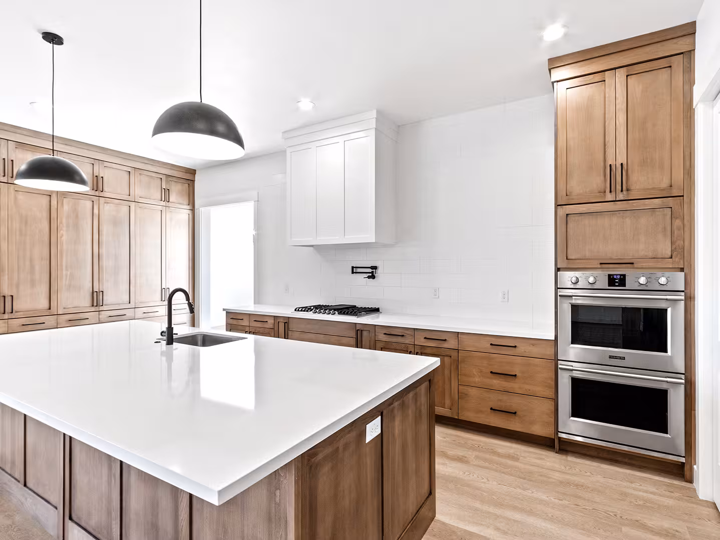 Paradise kitchen with double wall ovens, a gas cooktop and a pot filler on white tile
