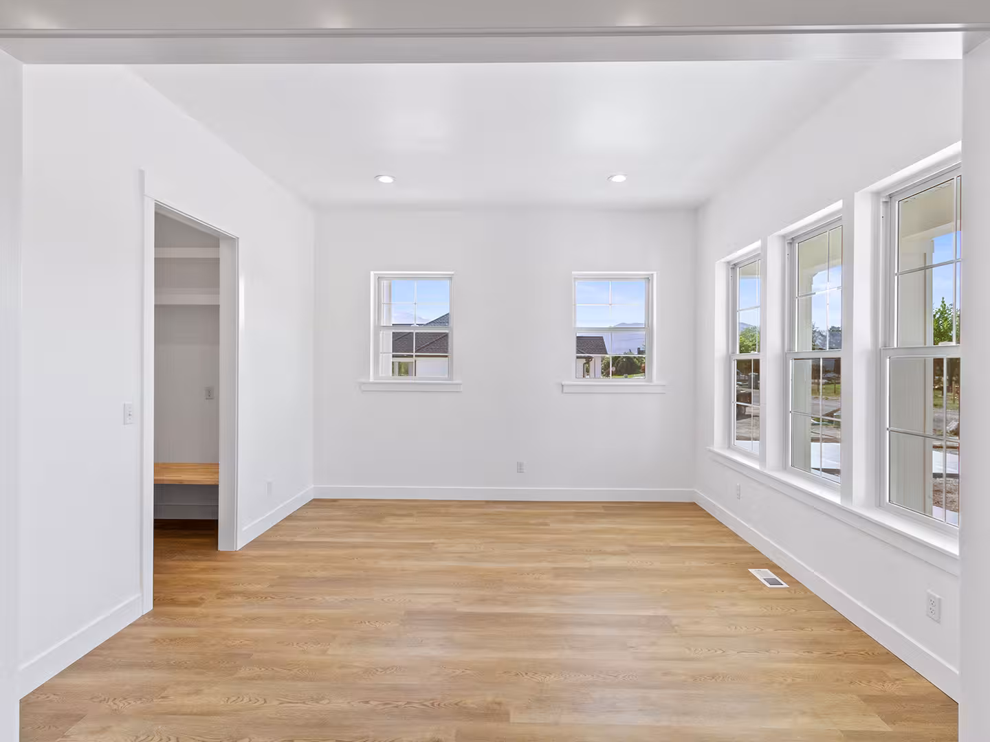 Bedroom in the Paradise home with a walk-in closet and windows on two walls