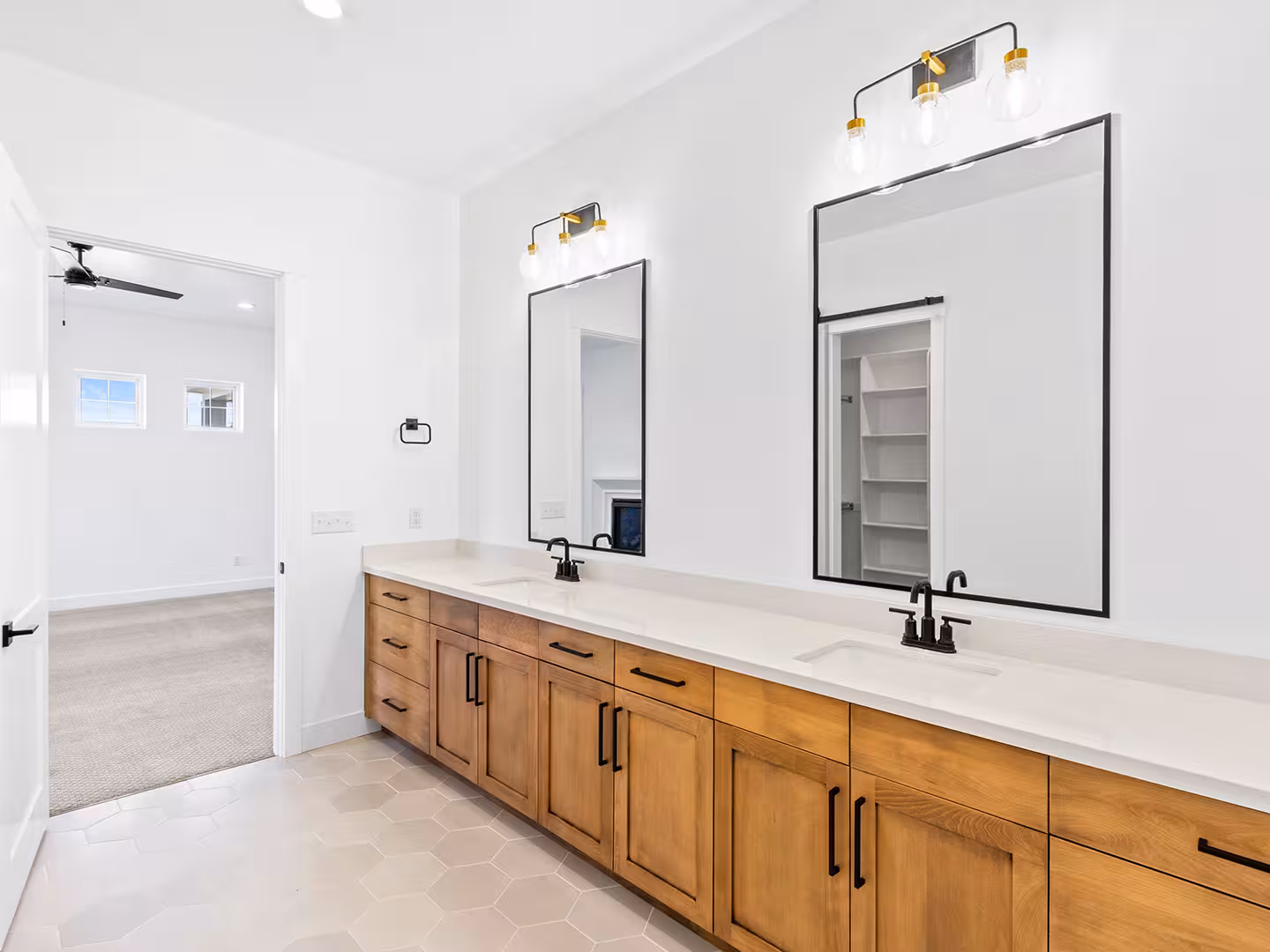 Paradise home bathroom with a long stained wood vanity and black-framed mirrors
