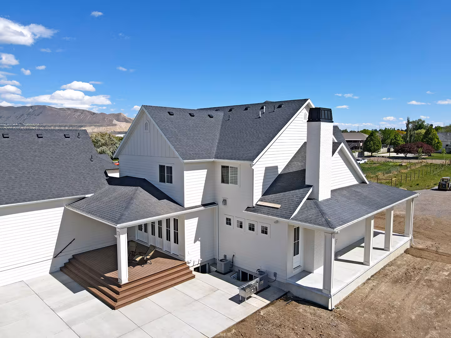 Aerial view of the back of the Paradise home with a covered porch and wood steps