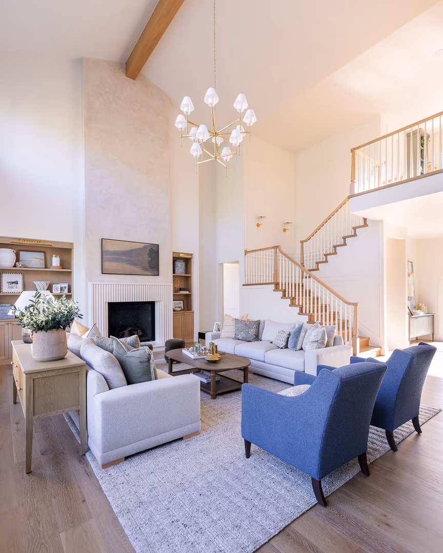 Perry great room with a vaulted ceiling, wood beam, fireplace and a staircase to the loft
