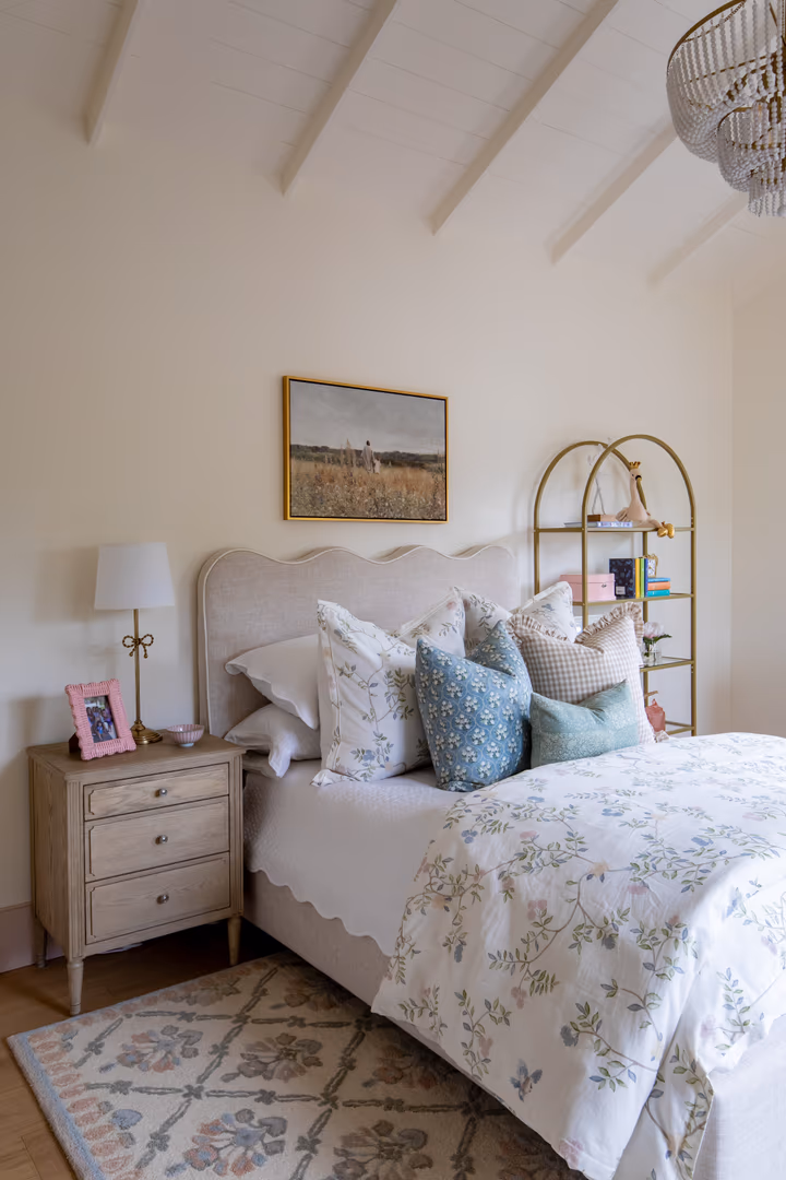 Girl's bedroom in the Vineyard home with a scalloped headboard and a white vaulted ceiling