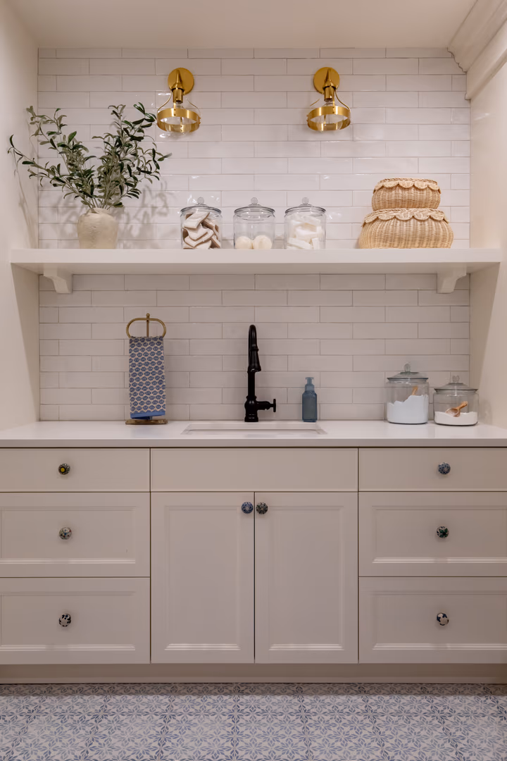 Vineyard home bar sink with white subway tile, a floating shelf and brass sconces