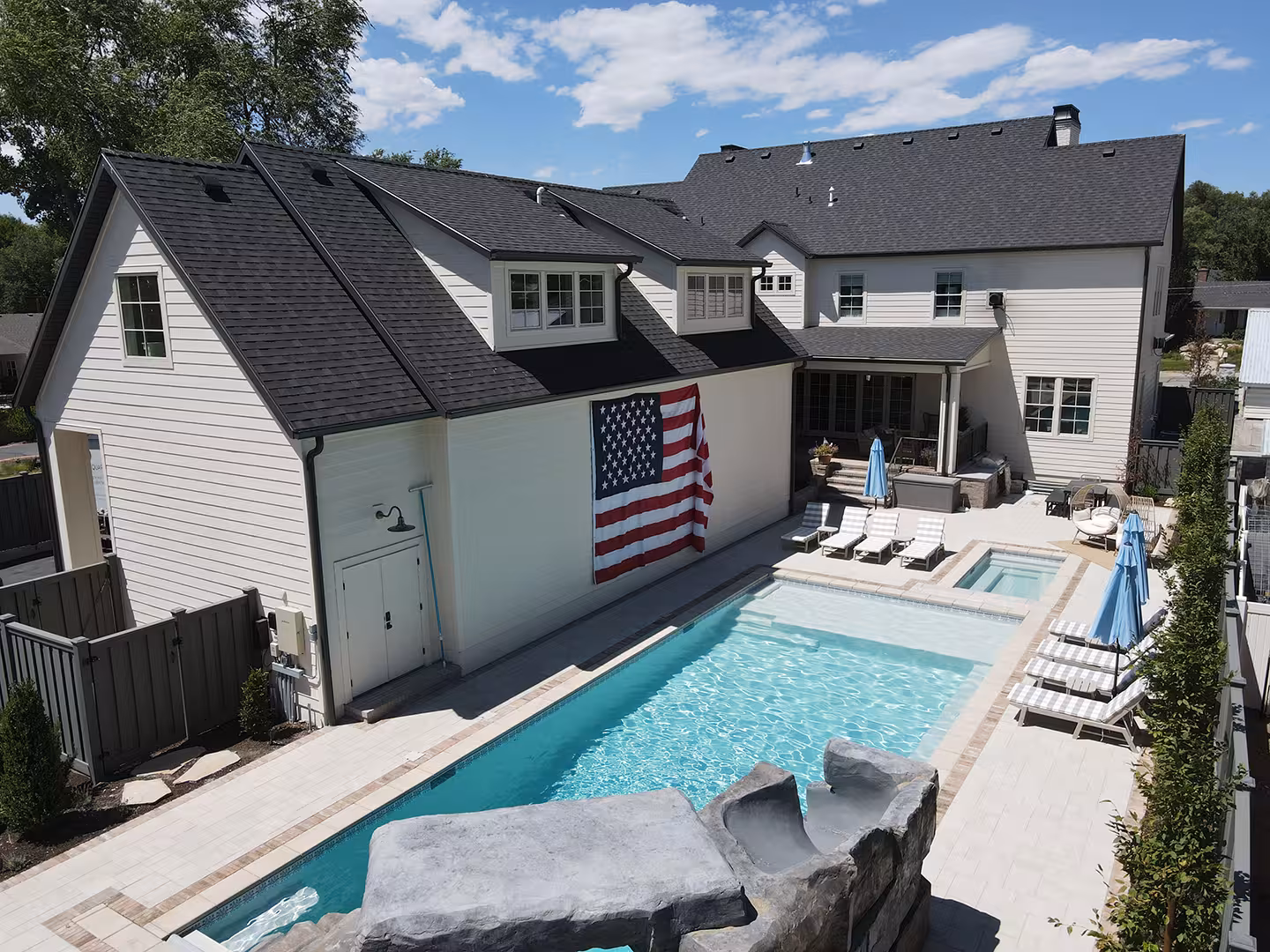 Backyard of the Vineyard home with a pool, spa, rock slide and covered patio